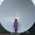 Abby in front of a small Dish