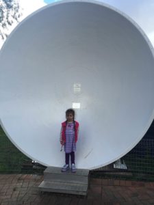 Abby in front of a small Dish