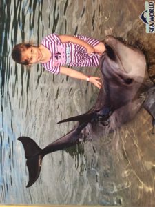 Abby patting Sunny the Dolphin