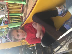 Abby kicking back on a train at Movie World, note that her T-Shirt is now on backwards.