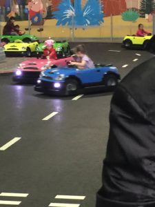 Abby driving a Blue Car