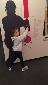 Abby demonstrating how to hold a Cricket Bat at the Bradman Museum in Bowral